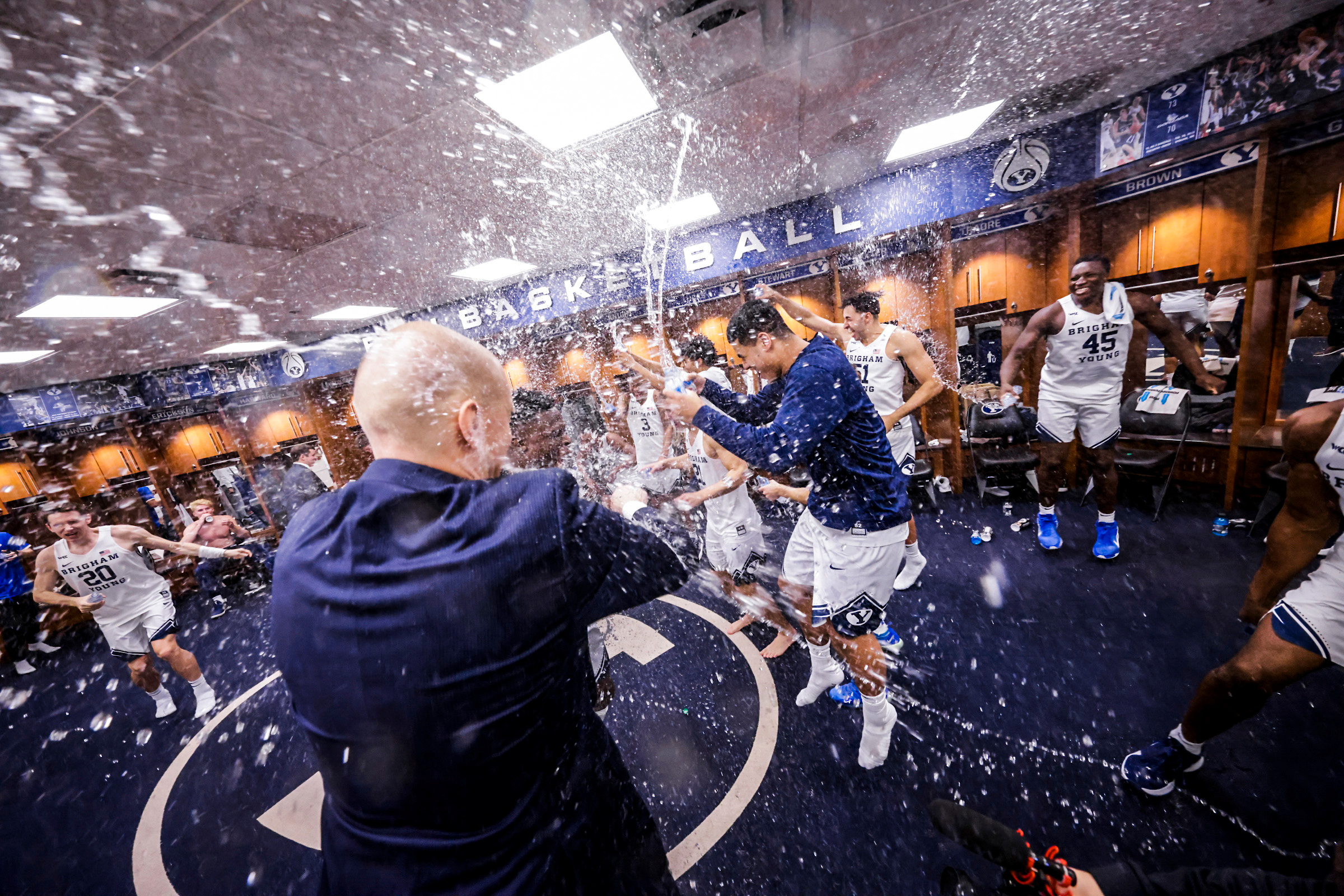 BYU postgame celebration in locker room with water bottles