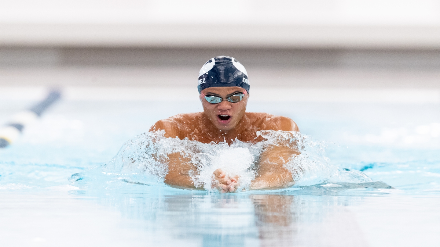 Josue Dominguez breaks the school record in the men's 100-yard breaststroke