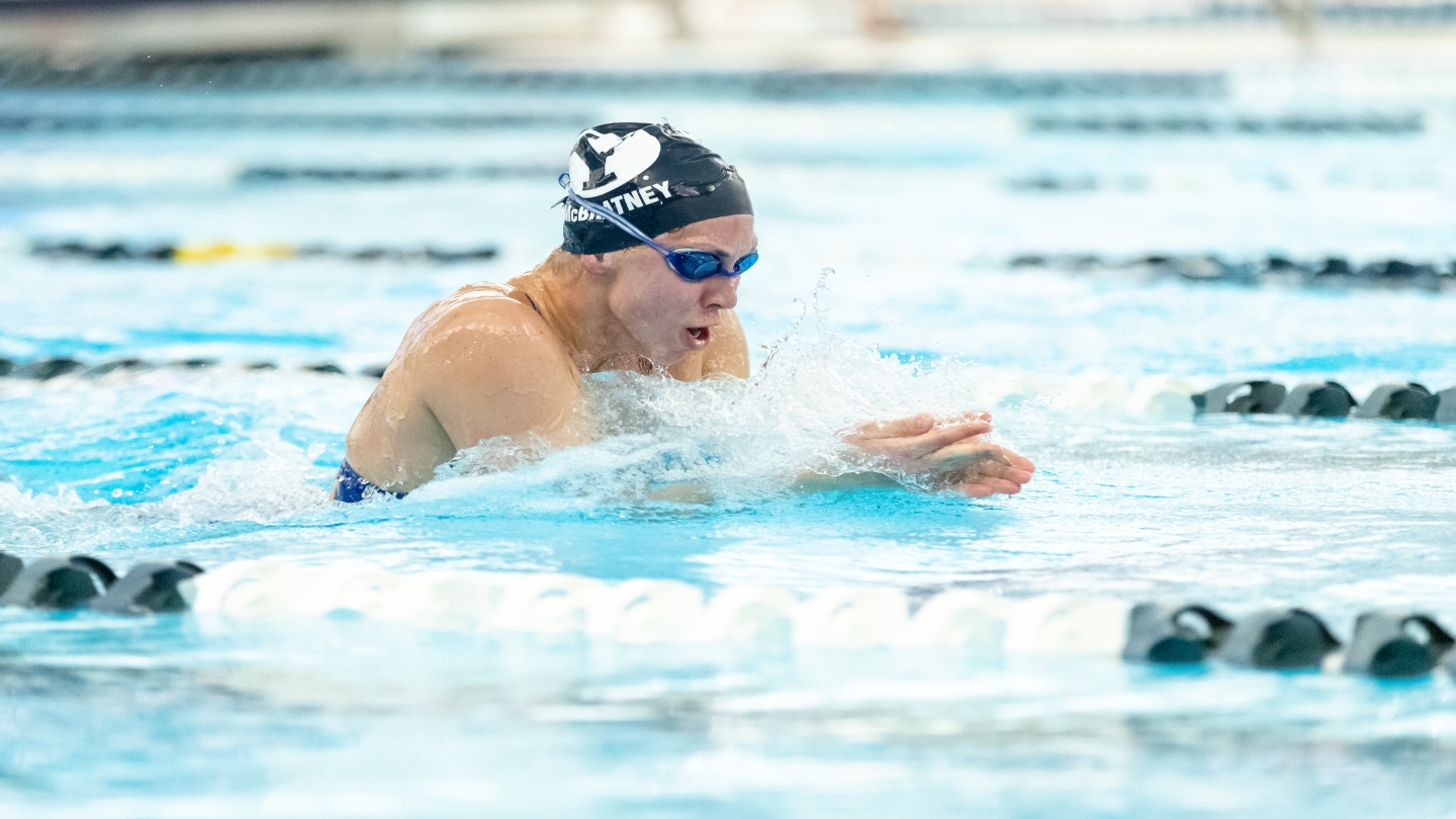 Katie McBratney swimming breaststroke, competing against Denver.