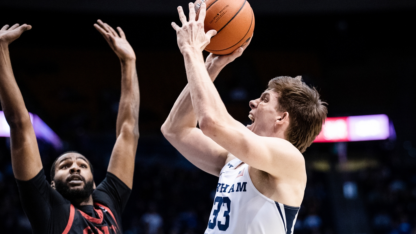 Dalton Nixon shoots a jump shot while a player from Southern Utah plays defense.