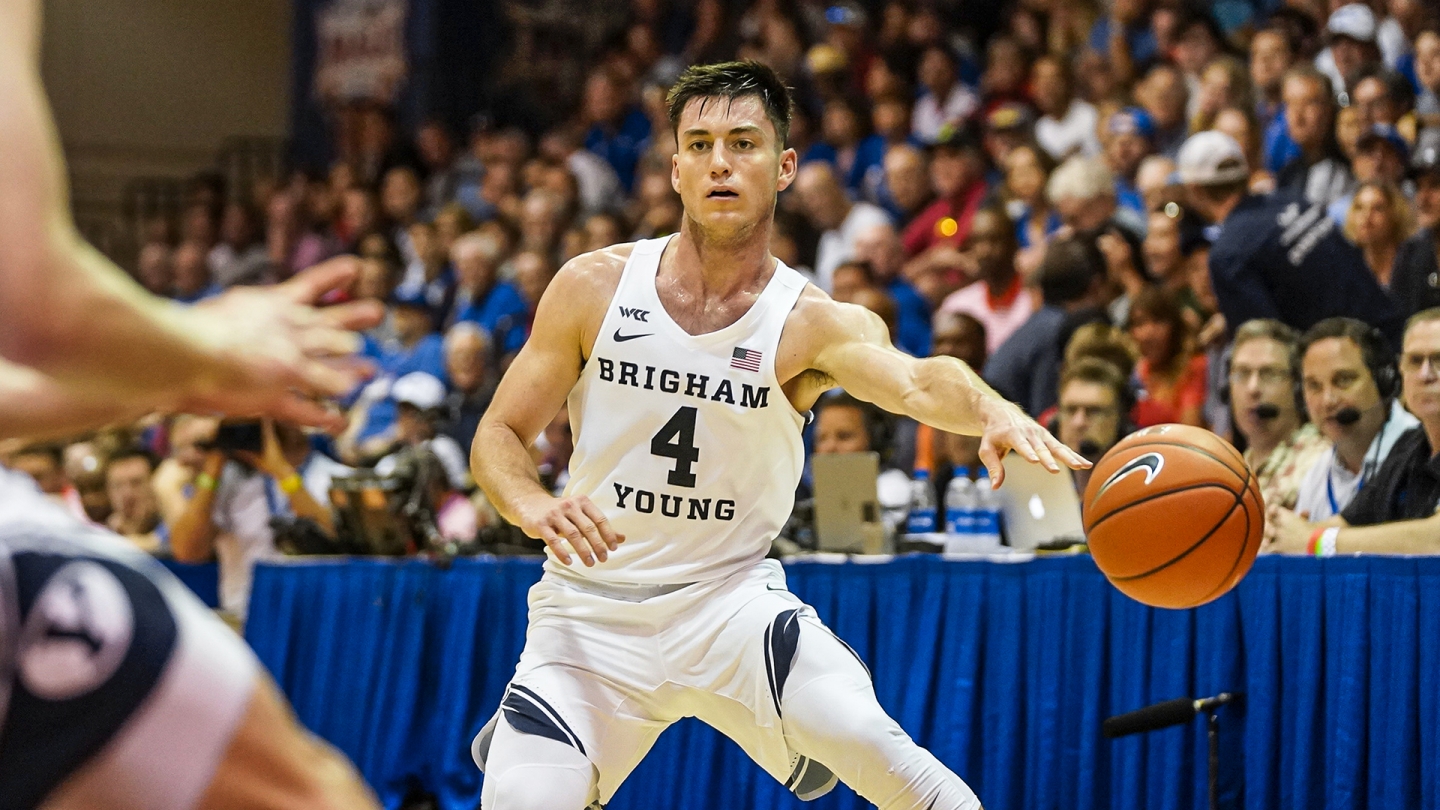 Alex Barcello passes the ball with his left hand against Kansas.